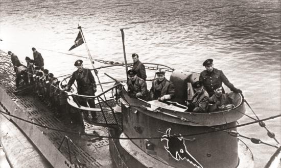 Several people on a U-boat in black and white. 