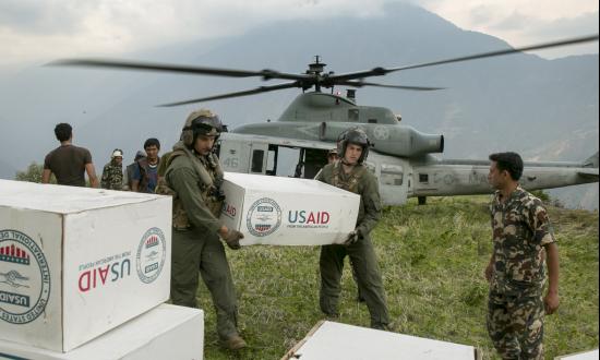 U.S. Marines and Nepalese soldiers unload tarps from a UH-1Y Huey