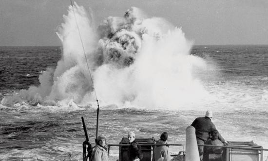 A Coast Guard combat cutter patrolling the North Atlantic looses a depth charge in battle practice sometime during World War II.