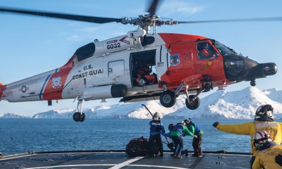 An MH-60T Jayhawk hovers over the flight deck of the USCGC Alex Haley (WMEC-39) while training for vertical replenishment in the Bering Sea.