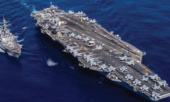 The aircraft carrier USS Carl Vinson (CVN-70), right, and the guided-missile destroyer  USS Dewey (DDG-105) prepare to transfer fuel during a replenishment-at-sea.