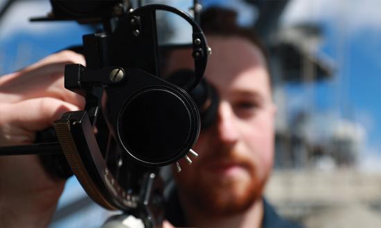A quartermaster on the USS Bataan (LHD-5) takes a celestial reading using a sextant in the Atlantic Ocean in March 2024. Readers have supported the call for better celestial navigation skills.