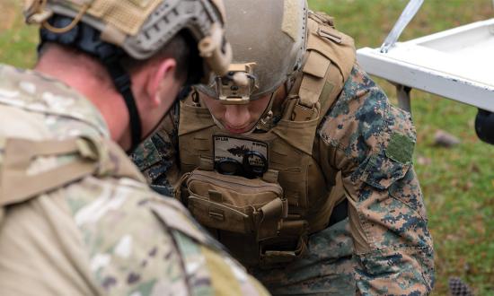 The MarSOC multicam pattern on the Raider in the foreground is not authorized for other Marines or their corpsmen.