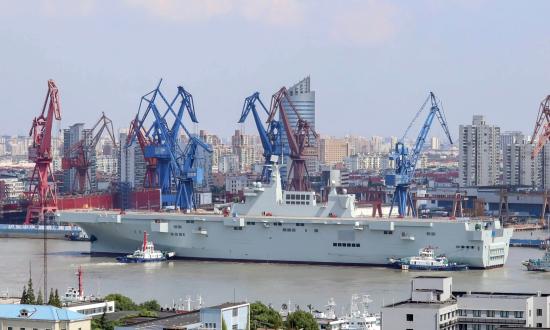 Aerial port quarter view of a Chinese Type-075 class amphibious assault ship