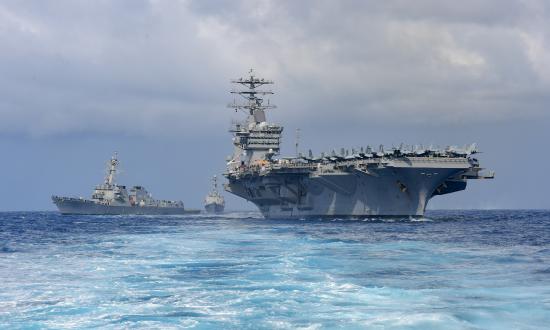The aircraft carrier USS Nimitz (CVN 68) steams ahead of the Arleigh Burke-class guided missile destroyers USS Howard (DDG 83) and USS Shoup (DDG 86) during a demonstration