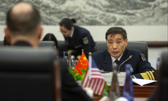 Chinese Navy Admiral Shen Jilong sitting at a table