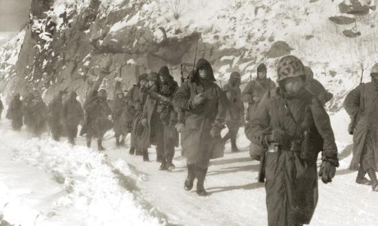 9 December 1950: Marines of the 1st Marine Division march through  mountain terrain in subzero weather during the Korean War’s Battle of Chosin Reservoir—one of the deadliest of the war.