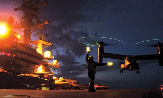 A U.S. Air Force CV-22B Osprey with the 352nd Special Operations Wing prepares to take off from the flight deck of a U.S. Navy Nimitz-class aircraft carrier.