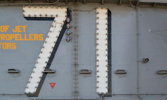 The warning painted on the superstructure of every aircraft carrier and amphibious assault ship above the flight deck—one of the most unforgiving working environments in the world.