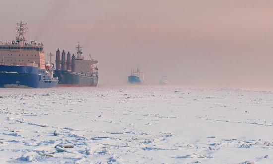 A Russian icebreaker leads ships through Arctic ice. 