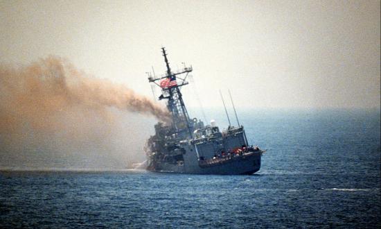 Port quarter view of the guided missile frigate USS STARK (FFG-31) listing to port after being struck by an Iraqi-launched Exocet missile, 5/18/1987