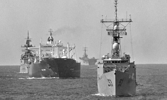 The guided missile frigate USS HAWES (FFG 53) leads the reflagged tanker GAS KING, guided missile cruiser USS WILLIAM H. STANDLEY (CG 32) and an aircraft carrier through the gul