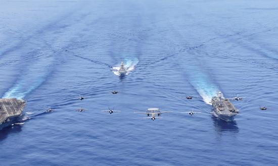 The Abraham Lincoln Carrier Strike Group (CSG) and the Italian Navy’s Cavour CSG sail in formation in the U.S. Seventh Fleet area of operations. The Navy’s reduced fleet now bears the weight of constant forward-presence missions, which are taxing the service’s operational resilience. 