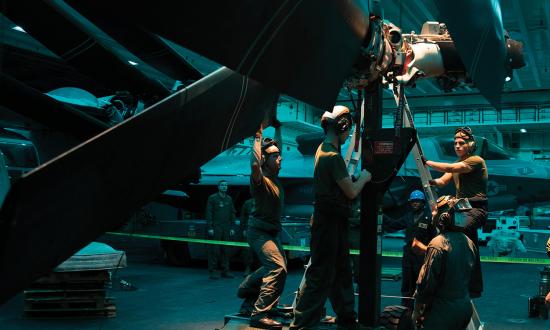 U.S. Marines and sailors conduct maintenance on the rotor assembly of an MV-22B Osprey. The Naval Air Training and Operating Procedures Standardization (NATOPS) requirements for rest must be followed for all personnel, not just the flight crew.