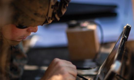 Marine Intelligence specialist monitoring the trajectory of the RQ-20 Puma surveillance and reconnaissance system