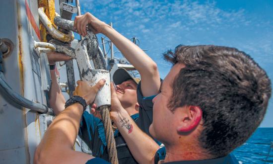 Sailors perform maintenance on a king’s post aboard the Arleigh Burke-class guided-missile destroyer USS Bainbridge (DDG-96)