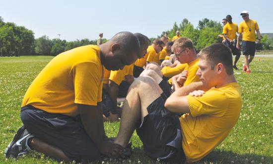 Enlisted sailors performing sit-ups