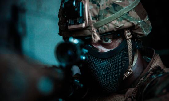 A Marine Corps rifleman during a night raid as part of a larger exercise.