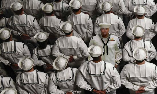 U.S. Sailors stand at parade rest during a Change of Command ceremony aboard the amphibious assault ship USS Wasp (LHD 1) in Subic Bay