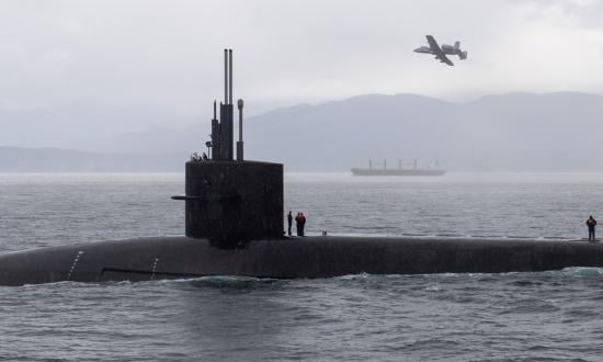 The Ohio-class ballistic missile submarine USS Nebraska (SSBN 739) transits the Strait of San Juan de Fuca escorted by U.S. Air Force A-10 Thunderbolt II aircraft and U.S. Coast Guard screening escort vessels. 