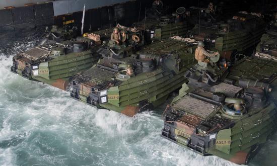 Marines and Sailors, assigned to the 26th Marine Expeditionary Unit, stage AAV P7/A1 assault amphibious vehicles in the well deck of the Harpers Ferry-class dock landing ship USS Oak Hill (LSD-51)