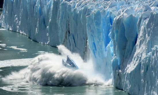 Iceberg falling into the ocean