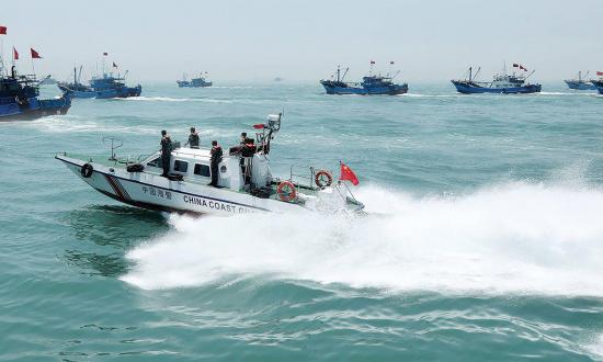 A China Coast Guard vessel patrols near fishing boats at sea. The U.S. Navy is unprepared to detect the potential threats of the malignant civilian commercial vessels of the People’s Armed Forces Maritime Militia, which often look like fishing boats but regularly integrates into the China Coast Guard and the People’s Liberation Army Navy. 