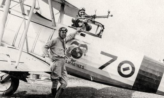 First Lieutenant Christian F. Schilt and his gunner, who did not fly during the Quilali flights, pose with their aircraft at Ocotal.