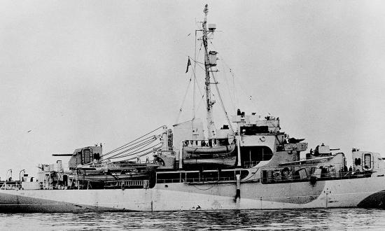 The Eastwind is shown off the coast of Greenland in her World War II state, including her Arctic camouflage. Note the twin dual 5-inch/38-caliber gun houses fore and aft.