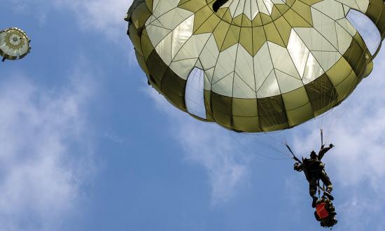 Japan Ground Self-Defense Force soldiers from the 1st Airborne Brigade descend from a U.S. Air Force C-130J Super Hercules over Narashino Training Area, Japan, in April 2022.