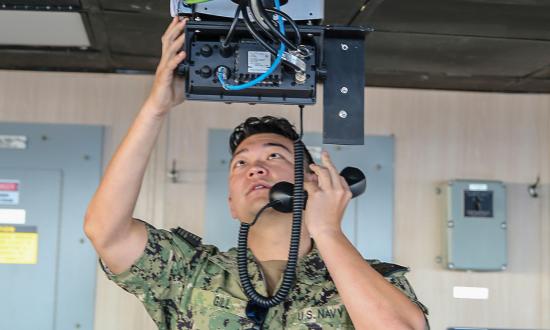 Strategic sealift officer runs radio tests in the USNS Benavidez (T-AKR-306).