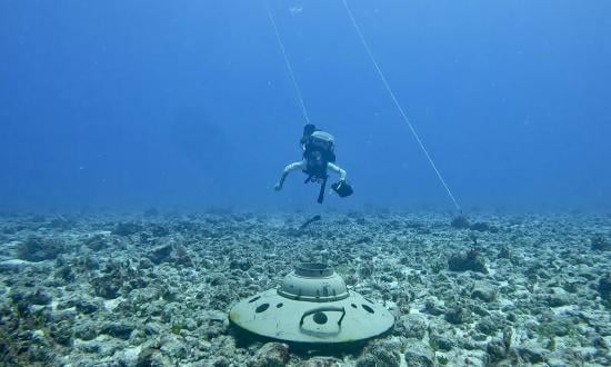 An explosive ordnance disposal technician disposes of a training mine. The technology and ideas to revive U.S. mine warfare are available and plentiful, but the community lacks a command structure to cohesively advocate, support, and properly conduct mine warfare.     