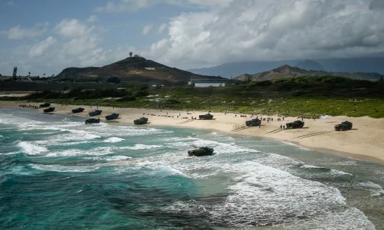 AAV-P7/A1 assault amphibious vehicles assigned to Combat Assault Company, 3rd Marine Regiment, unload service members during an amphibious landing demonstration as part of Rim of the Pacific (RIMPAC) exercise at Pyramid Rock Beach on Marine Corps Base Hawaii July 29, 2018