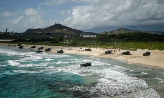 AAV-P7/A1 assault amphibious vehicles assigned to Combat Assault Company, 3rd Marine Regiment, unload service members during an amphibious landing demonstration as part of Rim of the Pacific (RIMPAC) exercise at Pyramid Rock Beach on Marine Corps Base Hawaii July 29, 2018