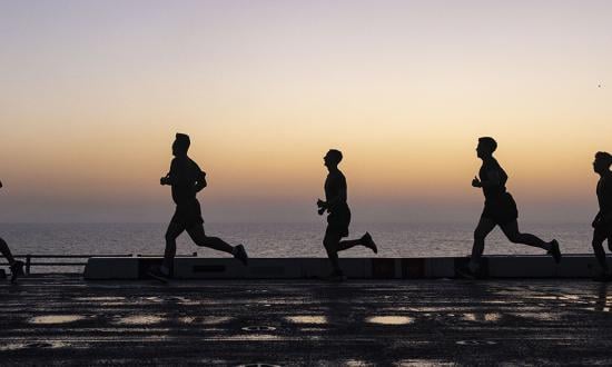 U.S. Marines and sailors run on the flight deck of the USS Mesa Verde (LPD-19). Information warriors operating in the cyber domain are a distinct class of warfighter. Recruiting requirements should reflect this reality. 