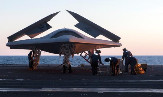 A Lockheed Martin X-47 unmanned combat air vehicle on an aircraft elevator on board the USS George H. W. Bush (CVN-77) in 2013, before the X-47 became the first fixed-wing unmanned aircraft to launch and recover from an aircraft carrier.