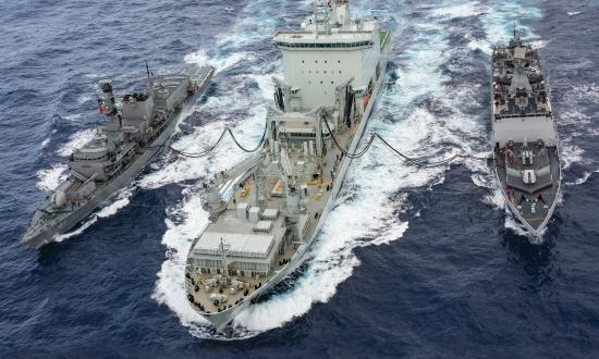 Chilean and Indian Navy Frigates perform replenishment at sea with a Royal Canadian Navy supply ship.