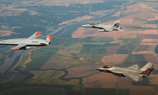 uncrewed MQ-25 Stingray refuels a manned F-35C joint strike fighter