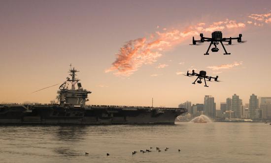 In this conceptual image, two small unmanned aerial vehicles race toward the USS Abraham Lincoln (CVN-72) as she transits the San Diego bay.