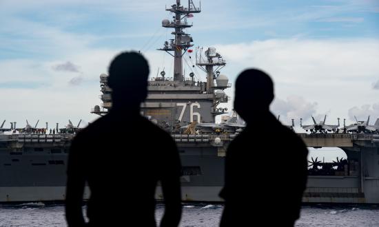 Navy Sailors observe the USS Ronald Reagan from the USS Nimitz. 