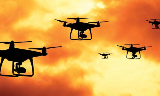 Drones against a cloudy orange sky