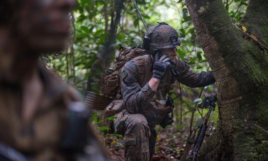A U.S. Marine platoon commander gives orders over the radio during Exercise Valiant Mark 2019 on Tekong Island, Singapore.