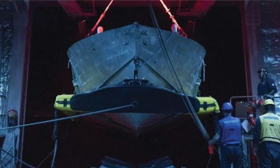 Sailors practice mine countermeasures unmanned surface vessel launch and recovery in the  mission bay of the Independence-variant littoral combat ship USS Cincinnati (LCS-20). The Navy should develop a robust unmanned capability dedicated to mine countermeasures.