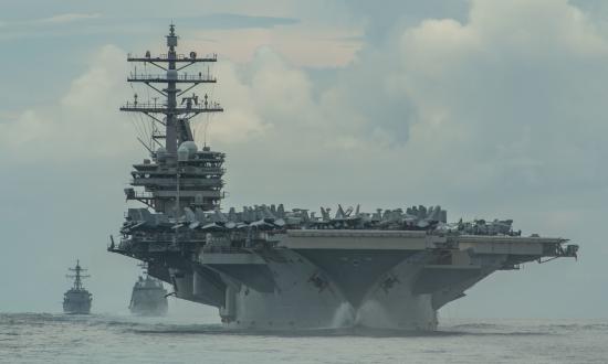 The Nimitz-class aircraft carrier USS Ronald Reagan (CVN-76) sails in formation with the Japan Maritime Self-Defense Force Akizuki-class destroyer JS Teruzuki (DD-116) and Arleigh Burke–class destroyer USS Mustin (DDG-89) in the Philippine Sea.