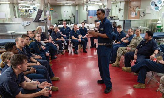 An ensign briefs sailors