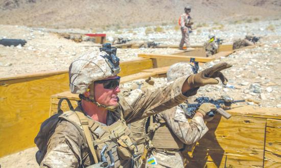 A platoon commander directs his platoon’s line of fire while on an exercise