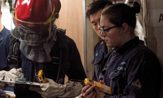 A hull maintenance technician trains a seaman on how to use a heptafluoropropane compartment casualty checklist during a damage control training exercise. Righting the checklist mentality would make sailors the best at their trade under the worst conditions.