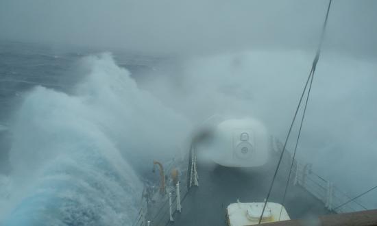 View looking down the bow of the USCGC Midgett (WHEC-726) as it breaks through heavy seas