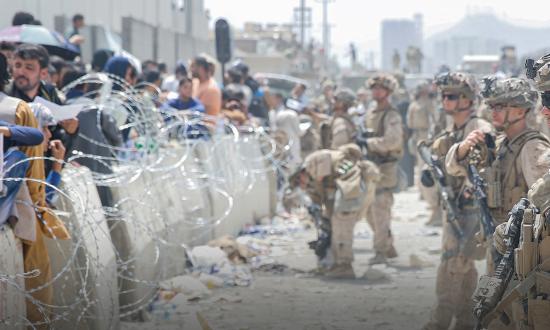 Marines provide assistance during the evacuation at Hamid Karzai International Airport, Afghanistan.