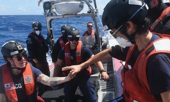 A Coast Guard auxiliarist completes a boarding at sea in the Indo-Pacific. Coast Guard auxiliarists are having a significant effect on manpower, filling critical billets and providing much-needed work-life balance to members.